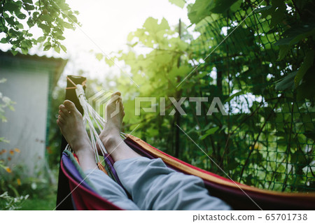 Male feet in hammock close-up, unrecognizable Male feet in hammock close-up, unrecognizable 65701738
