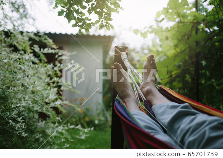 Male feet in hammock close-up, unrecognizable Male feet in hammock close-up, unrecognizable 65701739