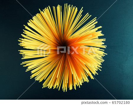 yellow raw long homemade spaghetti pasta on a black concrete background. Top view. Raw spaghetti bolognese. Italian food and diet concept. Copy space. 65702180