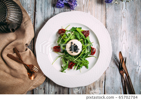 gourmet salad mozzarella caviar sun-dried tomatoes 65702784