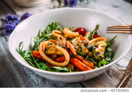 Seafood salad with vegetables and squid rings 65703093
