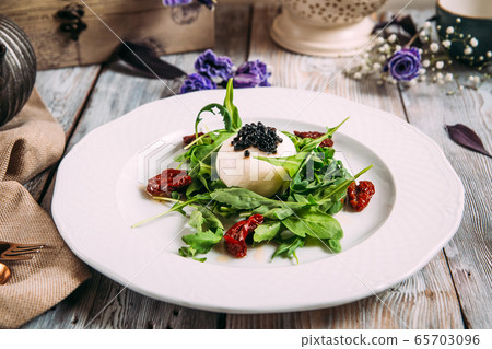 Gourmet salad mozzarella caviar sun-dried tomatoes Gourmet salad mozzarella caviar sun-dried tomatoes 65703096