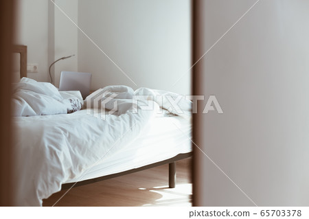 Working home isolation concept. Laptop in bed Working home isolation concept. Laptop in bed 65703378