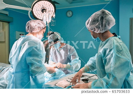 Surgeons team in the operating room, portraits close-up. modern operating, plastic surgery. Beauty industry 65703633