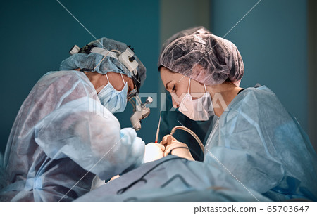 Surgeons team in the operating room, portraits close-up. modern operating, plastic surgery. Beauty industry Surgeons team in the operating room, portraits close-up. modern operating, plastic surgery. Beauty industry 65703647