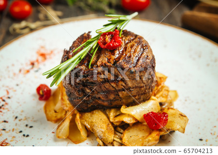 Appetizing filet mignon steak with potato chips Appetizing filet mignon steak with potato chips 65704213