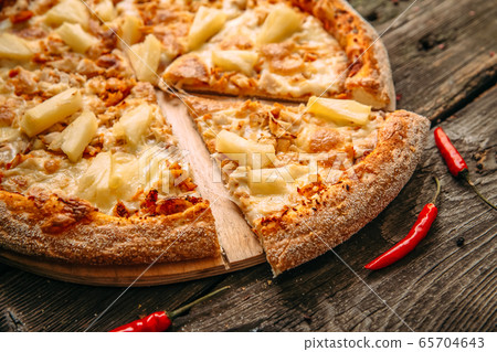 Closeup on appetizing hawaii pizza with pineapple Closeup on appetizing hawaii pizza with pineapple 65704643
