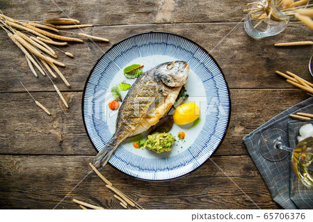 Top view appetizing gourmet grilled roasted fish Top view appetizing gourmet grilled roasted fish 65706376