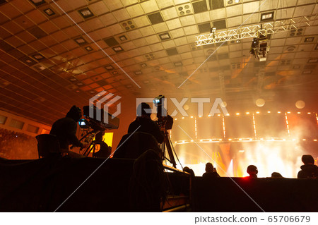 A group of cameramen working during the concert. 65706679