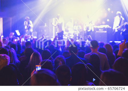 The audience watching the concert on stage. The audience watching the concert on stage. 65706724