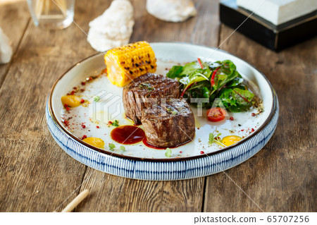 Appetizing grilled filet mignon steak with corn 65707256