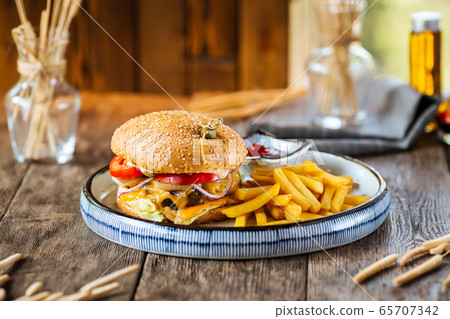 Closeup on cheeseburger with fries 65707342