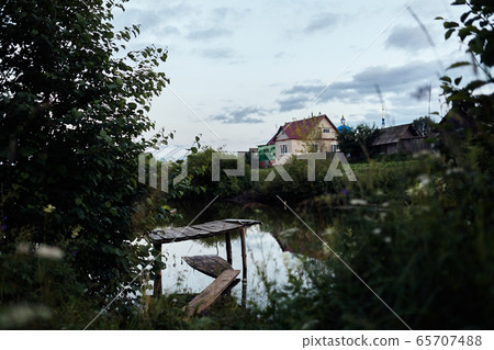 The bridge in the village by the pond The bridge in the village by the pond 65707488