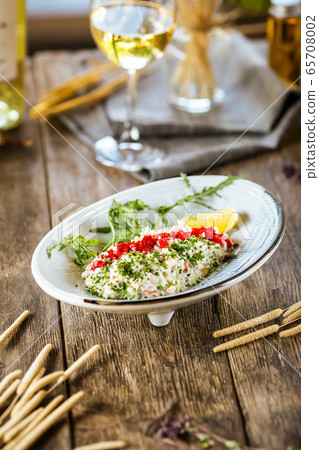 White salad with red caviar tobiko and green onion 65708002