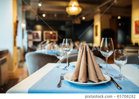 Served banquet restaurant table with wine glasses 65708282
