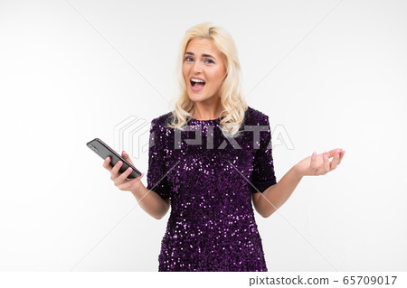 portrait of pretty blonde woman in elegant circuit board displeasedly holding a phone in rucksack on 65709017