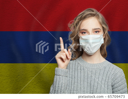 Woman in medical mask pointing up 65709473