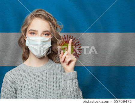 Woman in medical mask pointing up  65709475