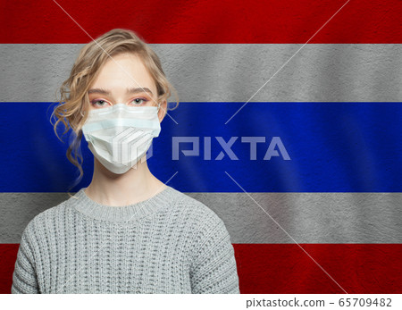 Young woman wearing a face mask with Thai flag. Young woman wearing a face mask with Thai flag. 65709482