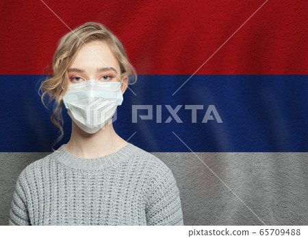 Young woman wearing a face mask with Serbia flag. Young woman wearing a face mask with Serbia flag. 65709488