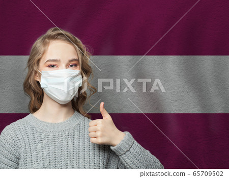 Happy woman in face mask holding thumb up Happy woman in face mask holding thumb up 65709502