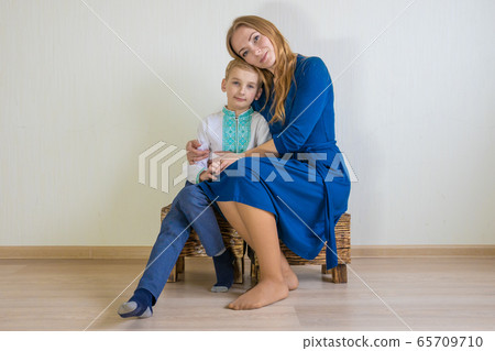 Happy young mother with her son in national Russian clothes. Happy young mother with her son in national Russian clothes. 65709710