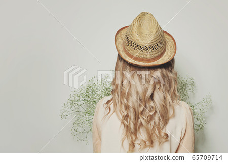 Beautiful blonde woman with curly hair  65709714