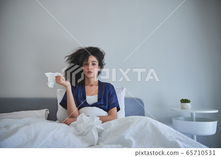 Serious international female person being on self-isolation 65710531