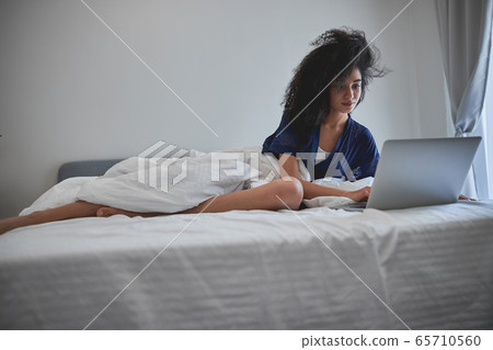 Young international woman working on distance at home 65710560