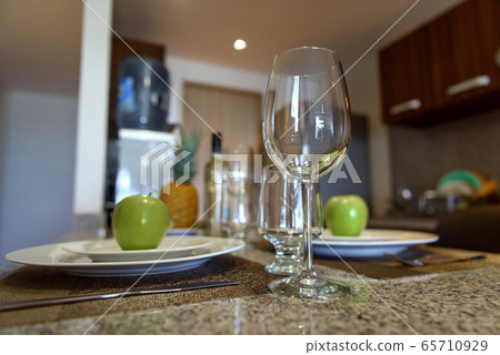 Wine glass on the table close-up. Cutlery in the 65710929