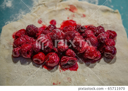 Dough with flour for making cherry pie Dough with flour for making cherry pie 65711970