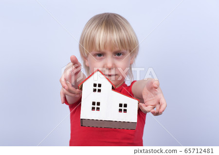 Sad kid throws model home. Orphanage, orphan, 65712481