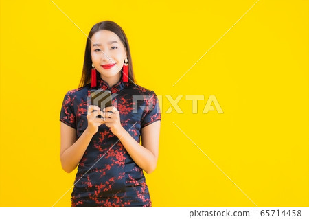 Portrait beautiful young asian woman wear chinese dress use smart mobile phone Portrait beautiful young asian woman wear chinese dress use smart mobile phone 65714458