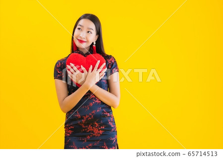 Portrait beautiful young asian woman wear chinese dress show heart shape pillow Portrait beautiful young asian woman wear chinese dress show heart shape pillow 65714513