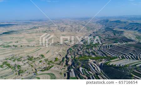 Aerial view of terraced farm field mass production during summer dry season Aerial view of terraced farm field mass production during summer dry season 65716654