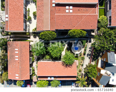 Aerial view of typical south california community condo with tennis court and pool 65716840