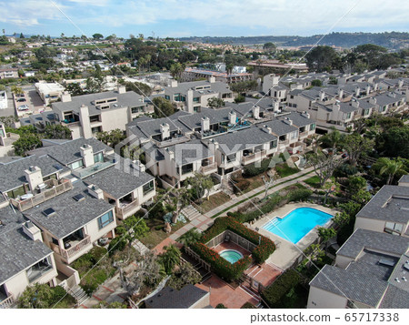 Aerial view of condo community with tennis court and pool in South California 65717338