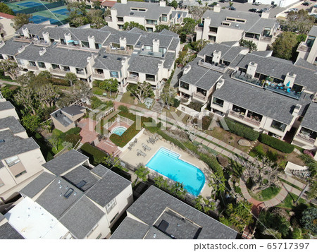 Aerial view of condo community with tennis court and pool in South California 65717397