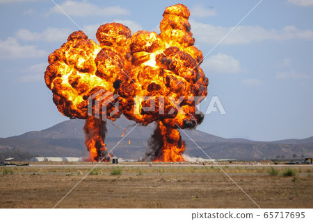 Giant outdoors explosion with fire and black smoke 65717695