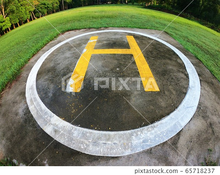 Closeup of helipad for landing helicopters on asphalt ground Closeup of helipad for landing helicopters on asphalt ground 65718237