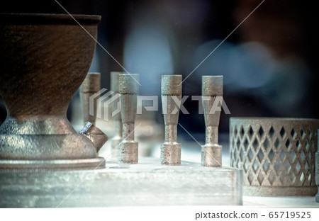 Man is holding object printed on metal 3d printer. Man is holding object printed on metal 3d printer. 65719525