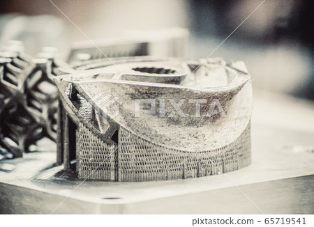 Man is holding object printed on metal 3d printer 65719541