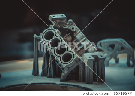 Man is holding object printed on metal 3d printer. 65719577