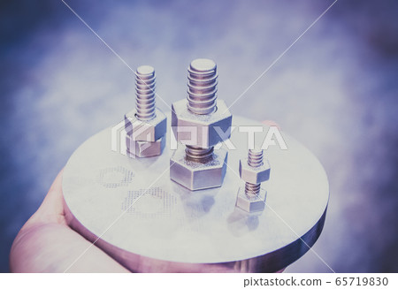 Man is holding object printed on metal 3d printer. 65719830