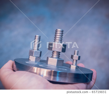 Man is holding object printed on metal 3d printer. Man is holding object printed on metal 3d printer. 65719831