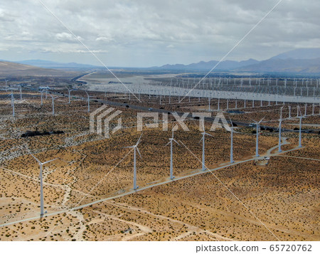 Aerial view of huge array of gigantic wind turbines spreading over the desert in Palm Springs. 65720762