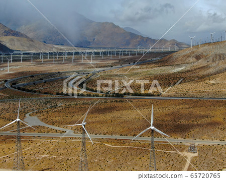 Aerial view of huge array of gigantic wind turbines spreading over the desert in Palm Springs. 65720765