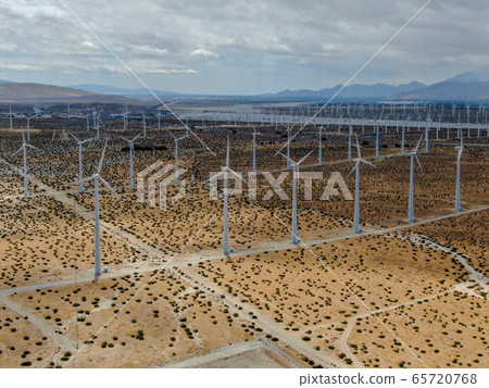 Aerial view of huge array of gigantic wind turbines spreading over the desert in Palm Springs. 65720768