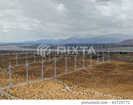 Aerial view of huge array of gigantic wind turbines spreading over the desert in Palm Springs. 65720772