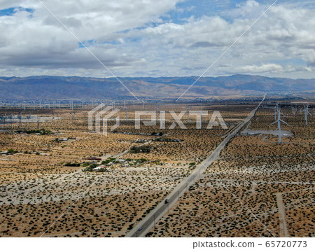 Aerial view of huge array of gigantic wind turbines spreading over the desert in Palm Springs. 65720773